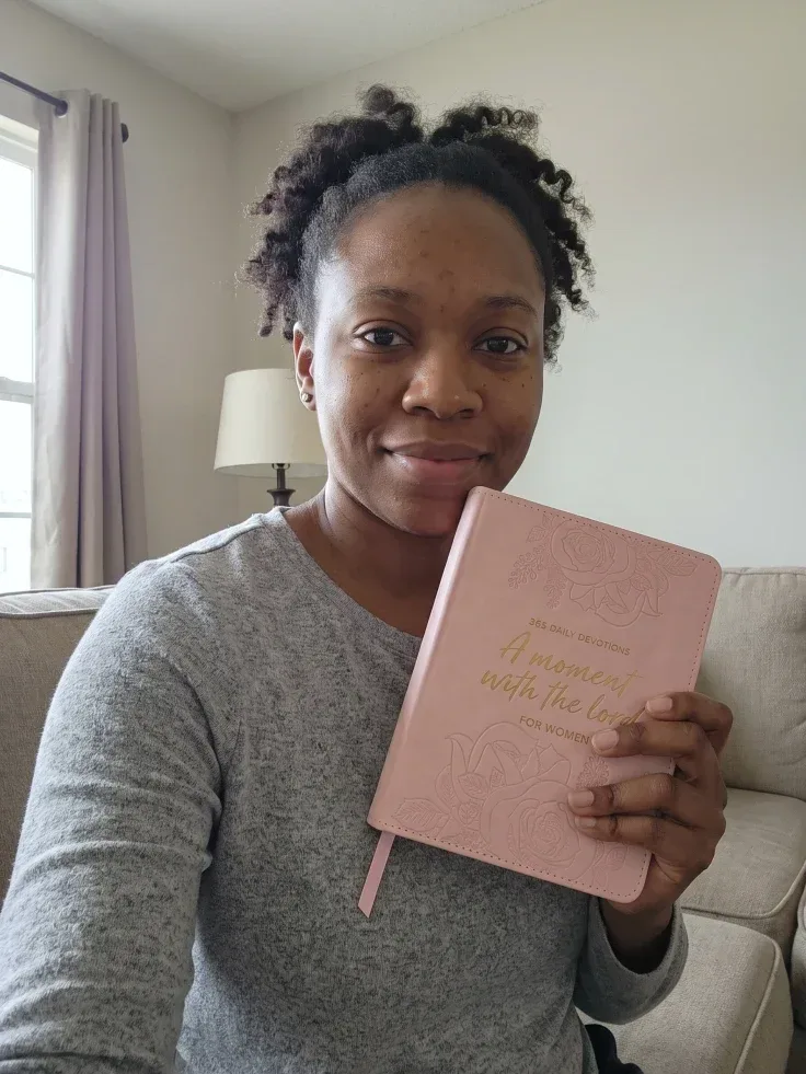 Customer photo: woman holding the pink devotional