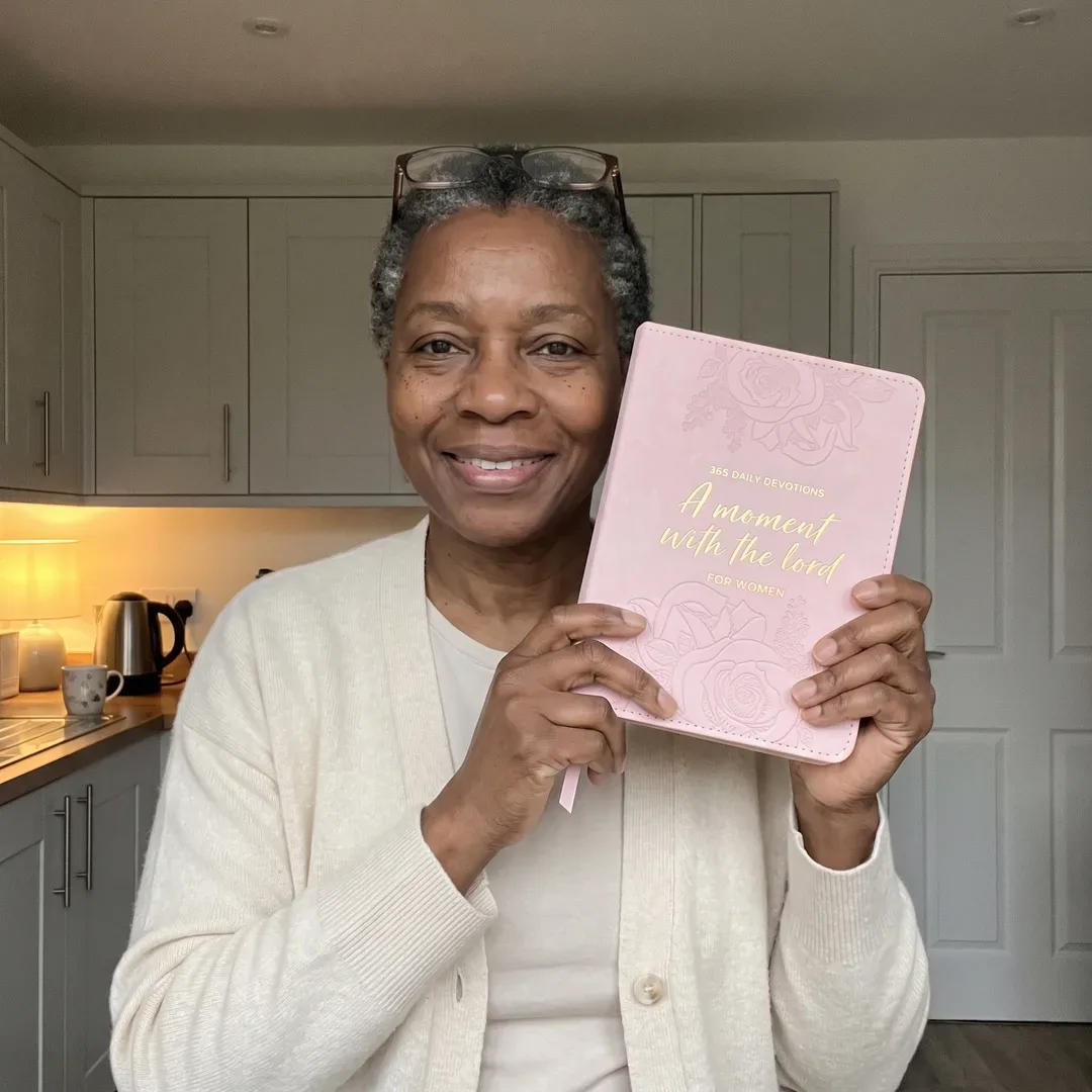 A woman reading A Moment With the Lord